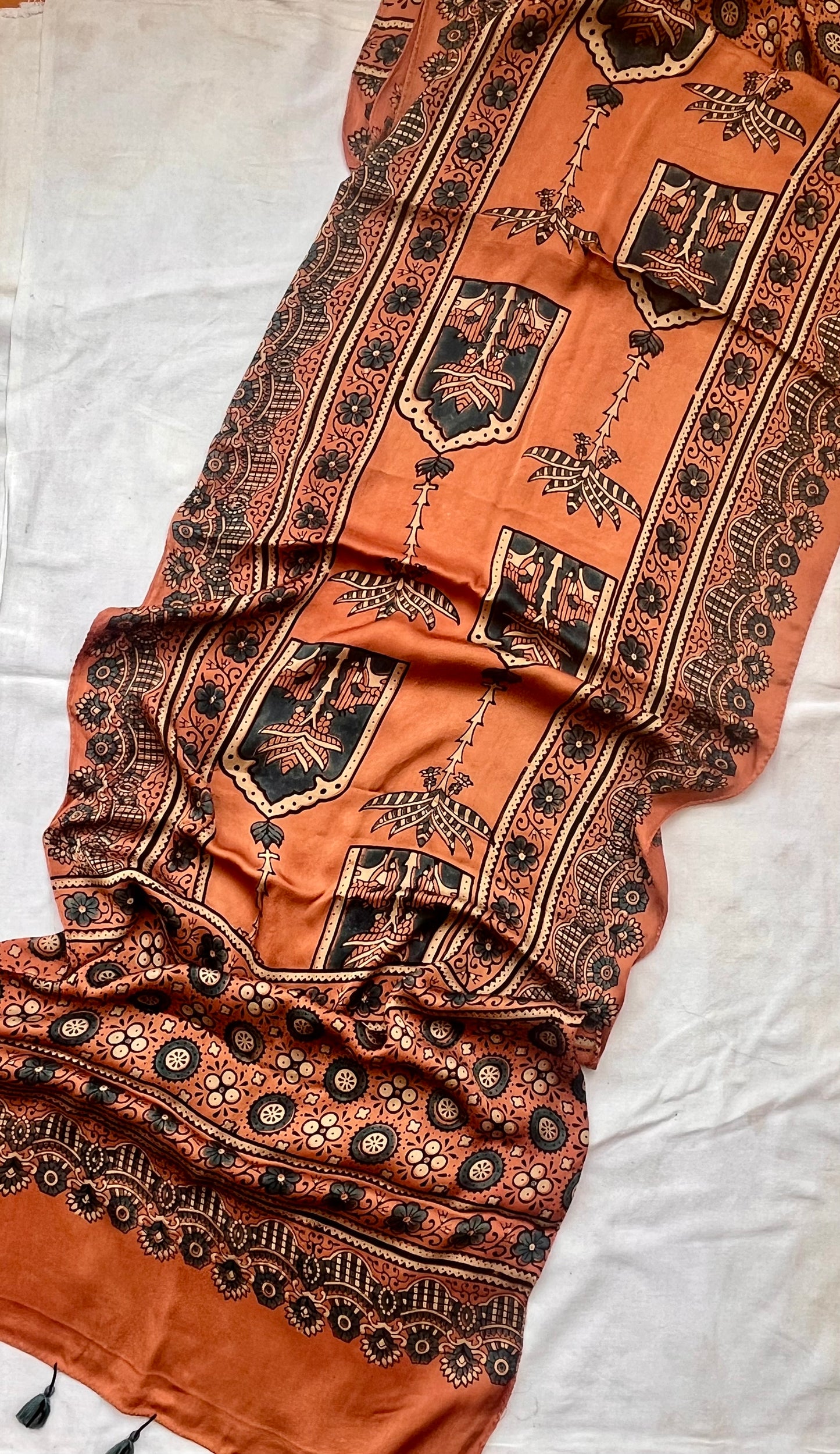 Kesari Jharokha and Kamdhenu Motif Ajrakh Hand Block Print Modal Silk Stole with Tassels